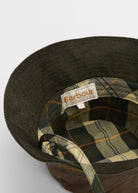 Underside of the brim in corduroy with tartan lining and woven Barbour label