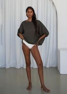 Mirror shot styled with matching linen shorts and bare feet