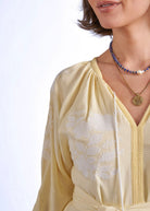 Side pocket detail with stacked pearl ring on the hand