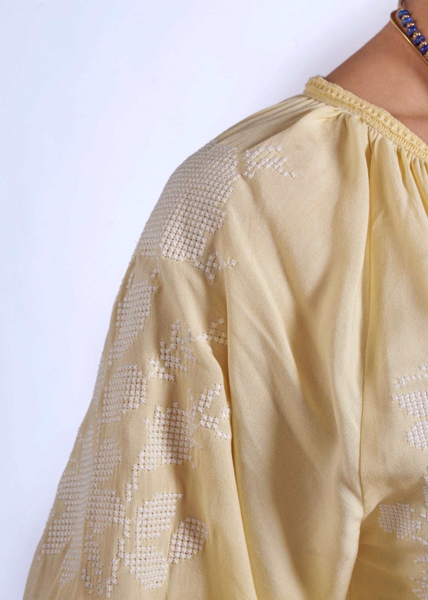 New Day Originals Front placket close-up, crochet trim with lapis bead necklace styling