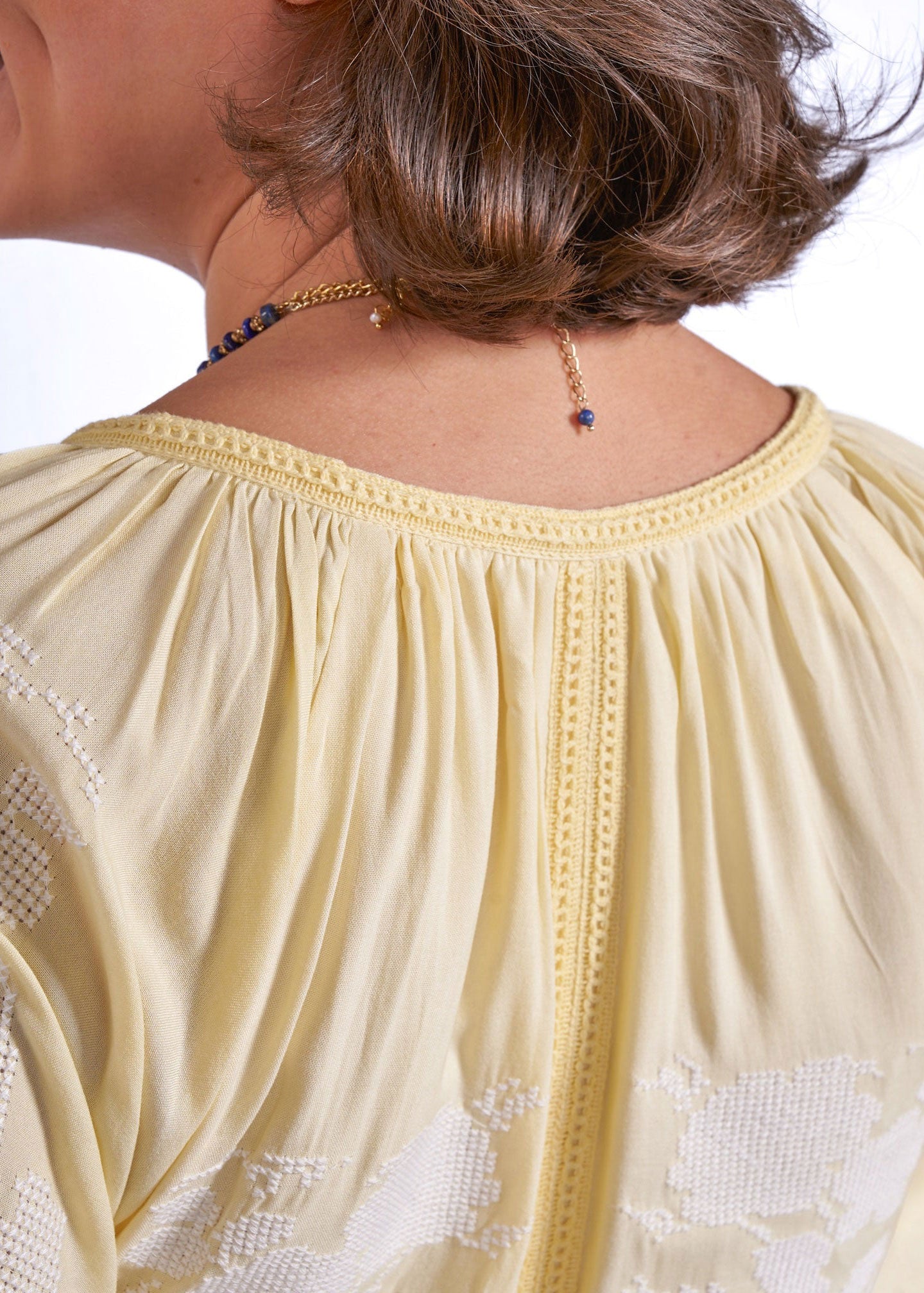 New Day Originals Back torso close-up, cross-stitch floral panels across sleeves and skirt