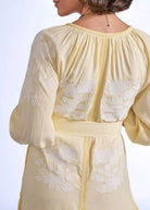 Skirt and ankle-tie sandals, embroidered floral motif at the hem