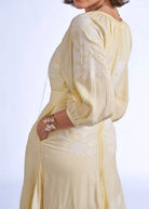 Shoulder close-up, gathered raglan yoke and embroidered balloon sleeve