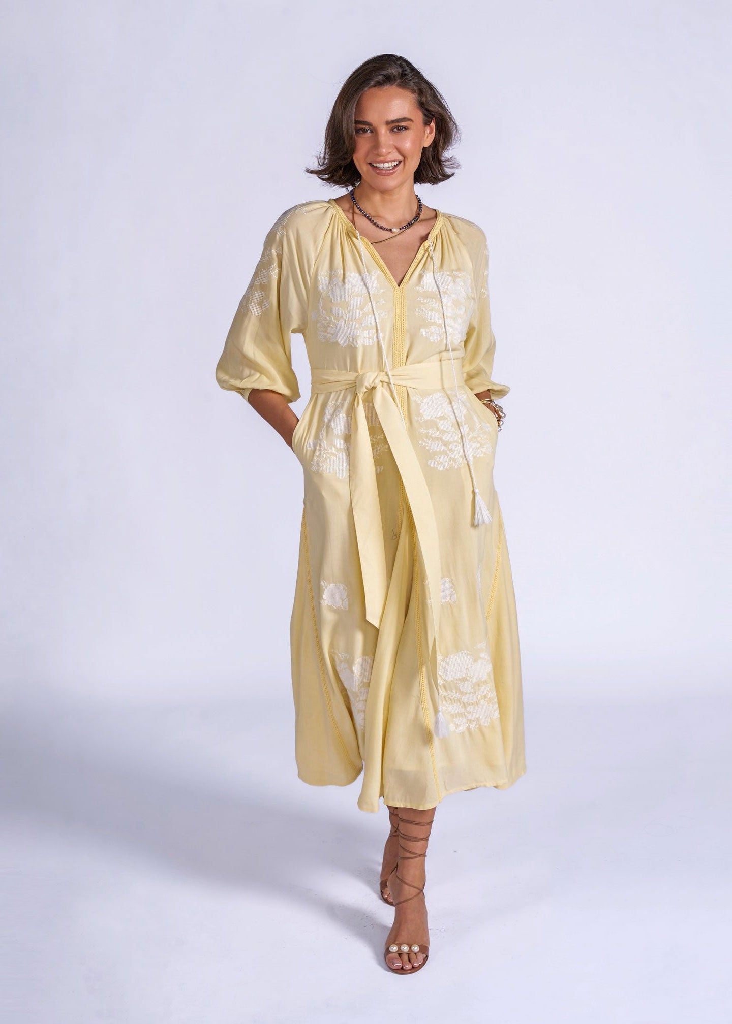 New Day Originals Walking front view with sash belt knotted and hands tucked in side pockets