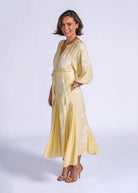Close-up of the V-neck placket, crochet trim and drawstring tassel ties