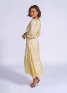Side smile, embroidered maxi styled with stacked pearl bracelets