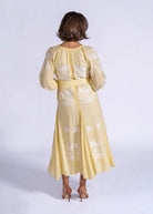 Rear three-quarter view, gathered round neckline and embroidered back panels