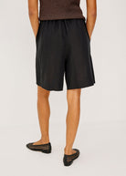 Back view, elasticated waist and full leg break at the knee