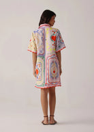 Back view with placement print and scalloped red trim at the hem