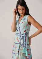 Side view with wrap-tie waist, zig-zag trim and aqua tassel ends