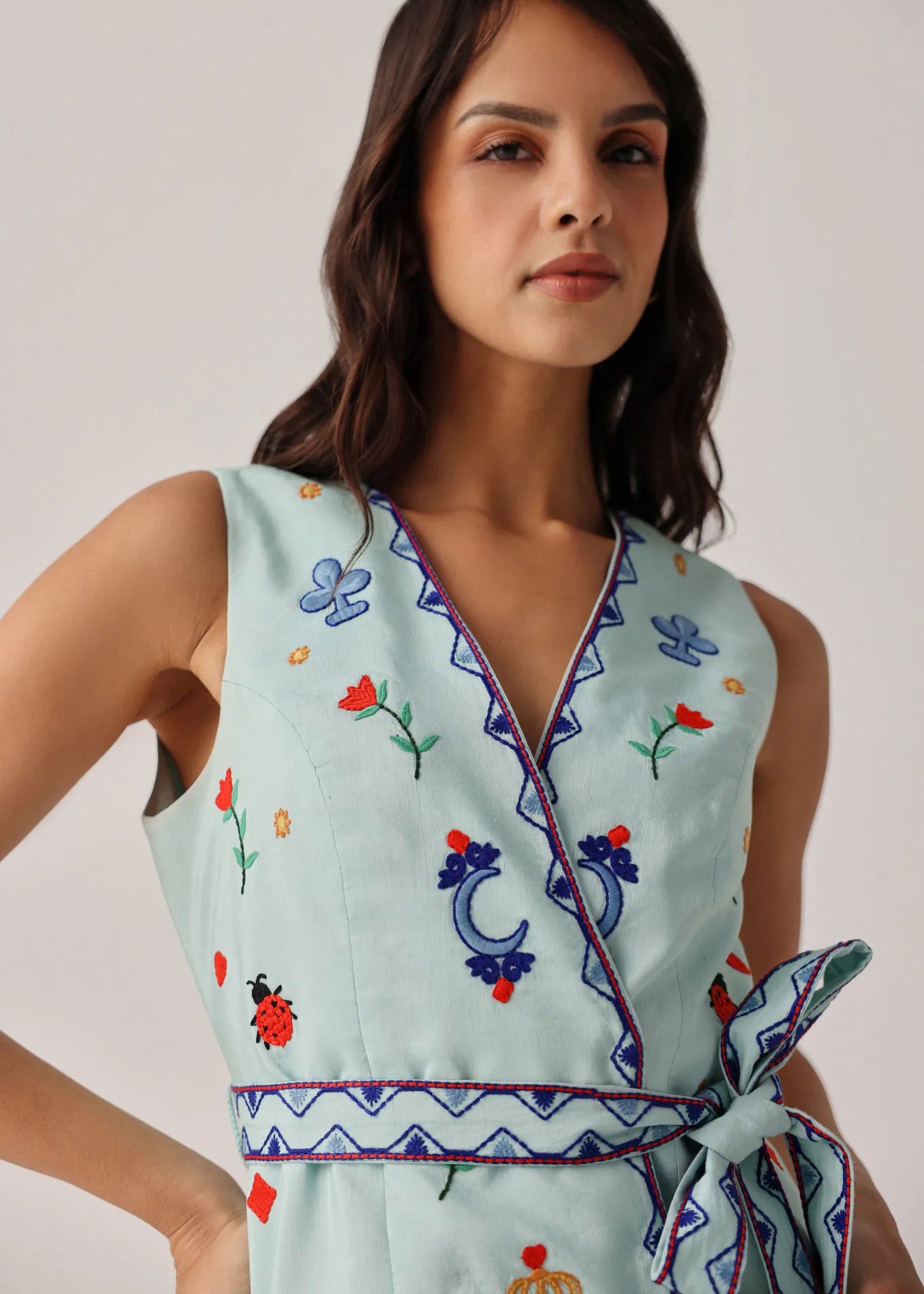 NOIB V-neck detail with folk embroidery, zig-zag rickrack and wrap closure