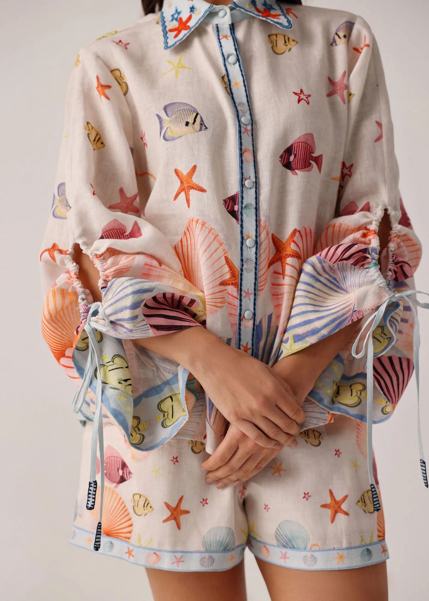 NOIB Front close-up styled with matching shell-print shirt and blue piping