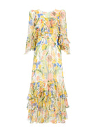 Front view, tiered ruffle hem and bell-sleeve cuffs on yellow and blue floral chiffon