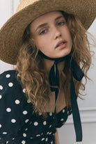Close-up of the black grosgrain neck ribbon and shirred bodice