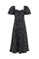 Front view, sweetheart neckline and puff sleeves on black polka-dot cotton