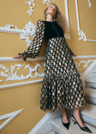 Leaning on the stair rail, balloon sleeve with ruffled cuff and gathered tiered skirt