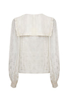 Back view, deep square collar with ruffle edge and gathered sleeves
