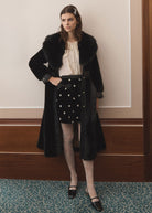 Queens of Archive Rosaline mini skirt, black velvet with pearl flower beading, worn under a faux fur coat