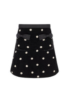 Front on white, satin waistband, bow-trimmed pockets and pearl and crystal flower beading