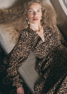 Close crop of the V-neck, puffed shoulder and fluted cuff, leopard print in detail