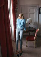Cropped length at a writing desk, styled with grey stirrup leggings and black patent shoes