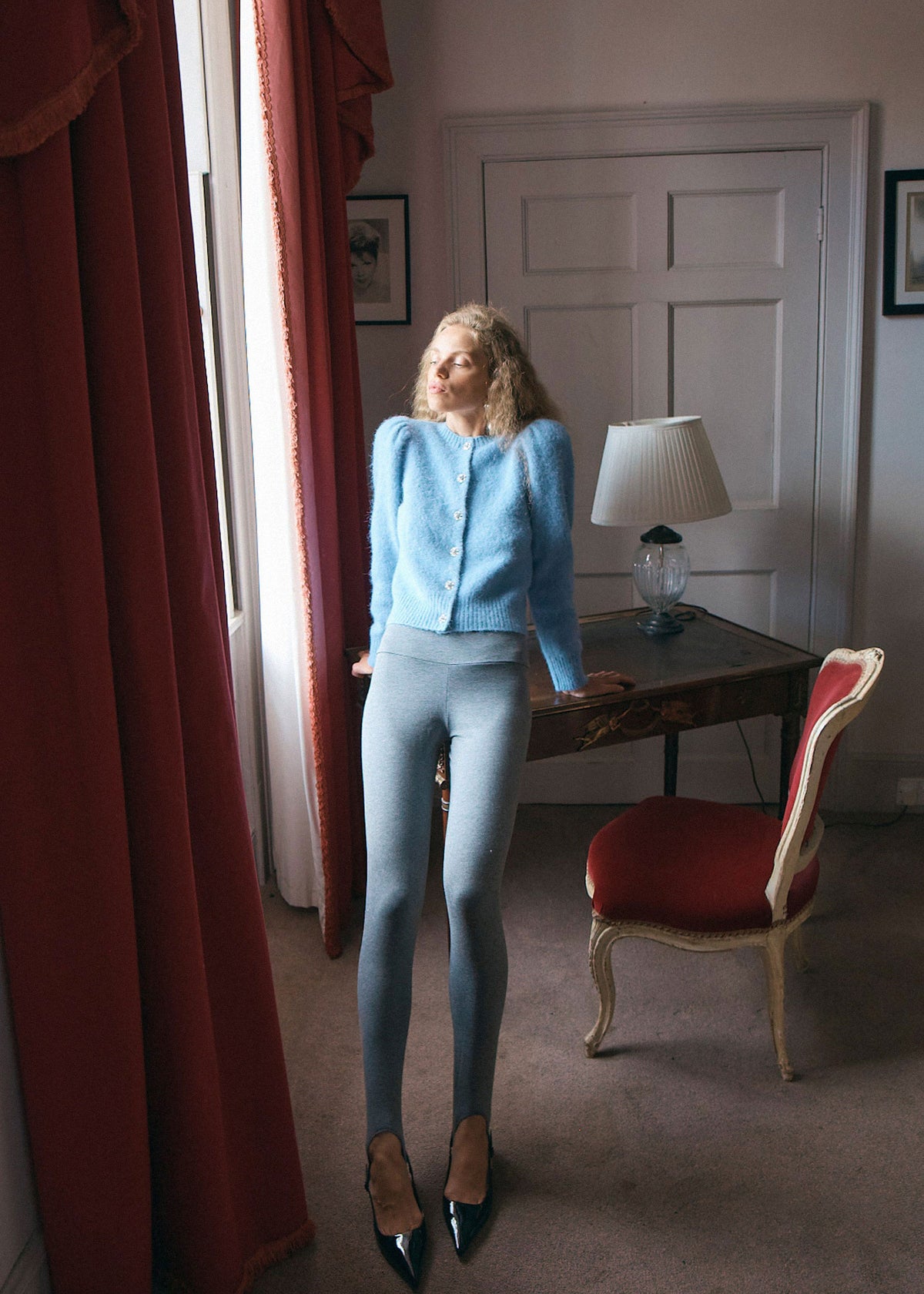 Queens of Archive Cropped length at a writing desk, styled with grey stirrup leggings and black patent shoes