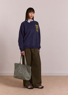 Back view, plain mint canvas with embroidered logo