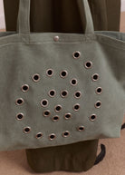 Three-quarter view, mint canvas tote with rolled handles