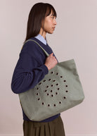 Detail of the swirly eyelet stitching across the tote front