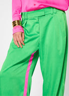 Close-up of the pleated waistband and contrast pink side seam stripe