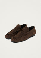 Pair angled to show the fringed apron and low stacked heel