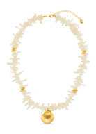 Detail view of the creamy coral chips and shell accents along the necklace