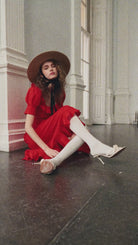 Seated styling shot with white knee socks and ivory heeled mules