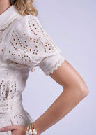Shoulder detail, scalloped collar and floral broderie at the puff sleeve