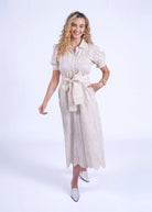 Walking front view, A-line skirt swinging through the broderie panels