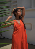 Three-quarter view among palm fronds, V-neck and A-line drape