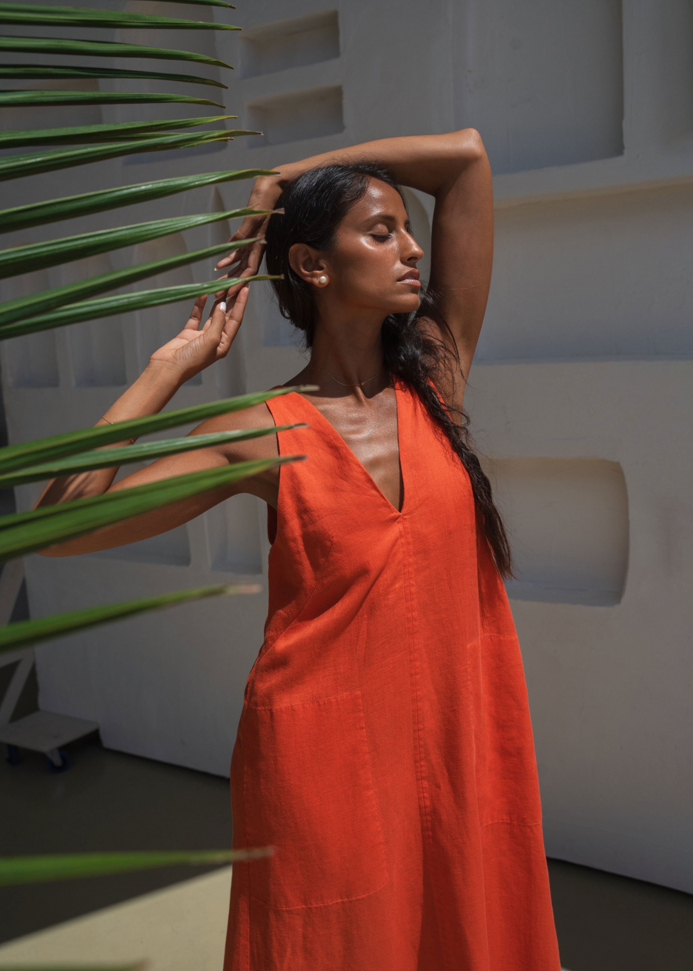 Lilly Pilly Three-quarter view among palm fronds, V-neck and A-line drape