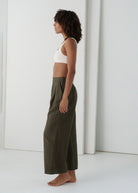 Side profile showing the cropped khaki wide-leg silhouette