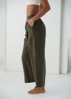 Side close-up, hand in patch pocket against the linen weave