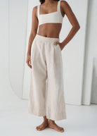 Waist down front view, pleated drape into a cropped hem