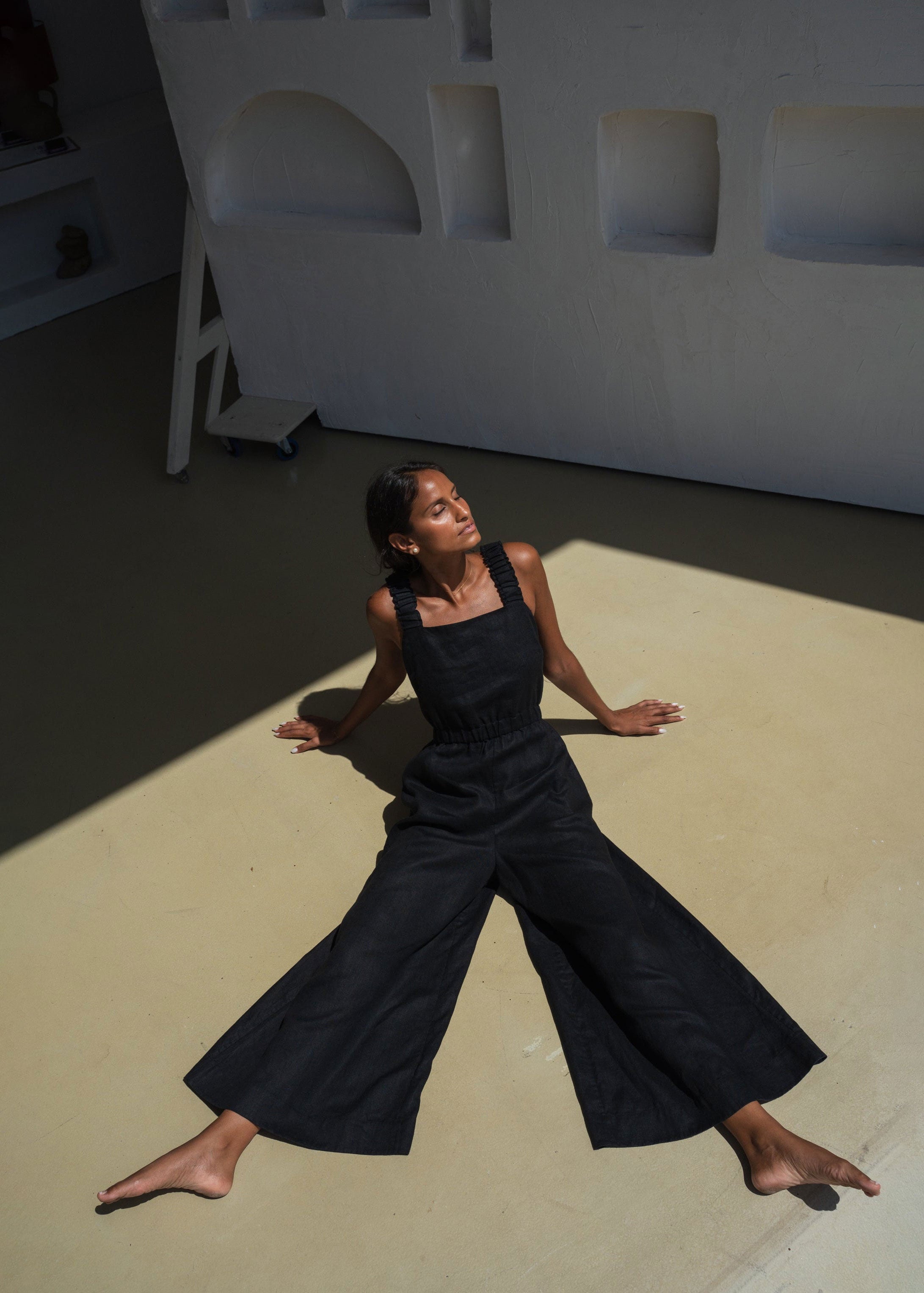 Lilly Pilly Wide-legged pose on the floor showing full sweep of the linen