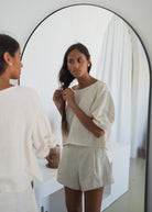 Mirror shot styled with the matching oatmeal linen shorts