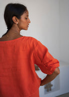 Three-quarter back showing the sleeve tuck detail