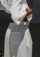 Back pocket close-up, ladder-stitch trim running down the seam
