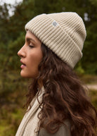 Side profile outdoors, snug fit with the cuff folded over the ears