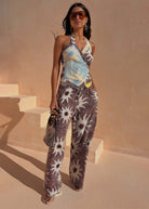 Styled with a draped halter top in soft blue contrast