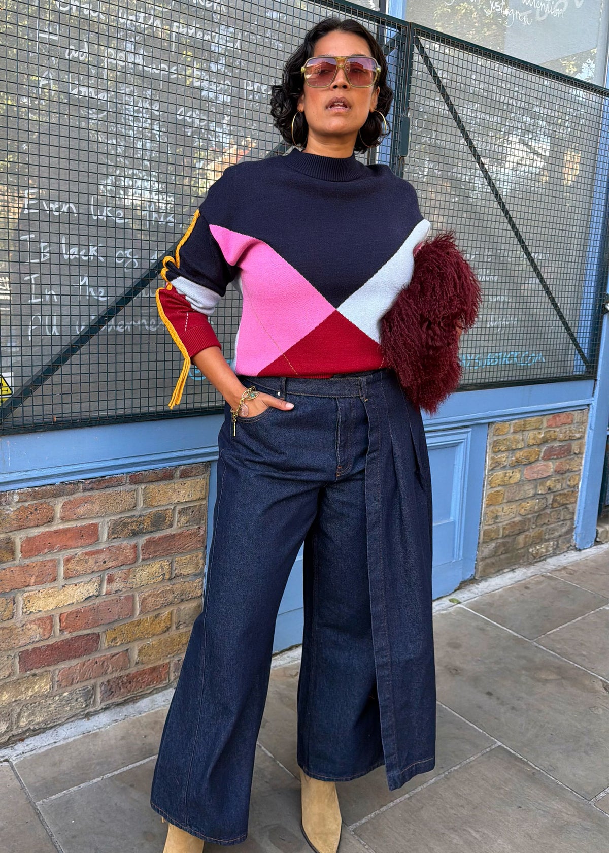 Never Fully Dressed Styled with wide leg dark denim and a shaggy burgundy bag