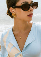 On-neck styling shot showing the pendant at the throat